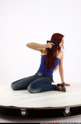 Woman Young Athletic White Fighting with gun Kneeling poses Casual