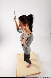 Woman Adult Athletic White Fighting with gun Standing poses Casual