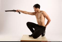 Man Young Athletic Fighting with gun Kneeling poses Pants Asian