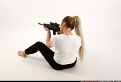 Woman Young Average Fighting with submachine gun Sitting poses Casual Asian