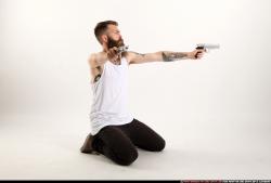 Man Adult Athletic White Fighting with gun Kneeling poses Casual