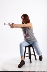 molly-sitting-aiming-pistol