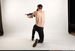 Man Adult Athletic White Fighting with submachine gun Kneeling poses Pants