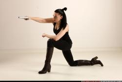 Woman Adult Athletic White Fighting with gun Kneeling poses Casual