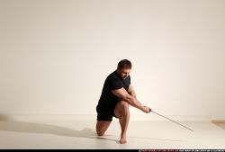 Man Adult Muscular White Fighting with sword Kneeling poses Sportswear