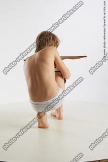 Kneeling boy with crossbow Novel